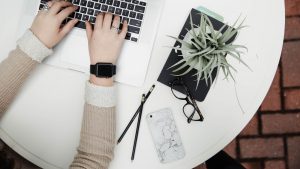 computer keyboard with hands, work from home desk set-up