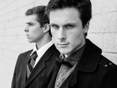 Young and Adult Men in Collared Shirts and Suit Jackets, focus on Face